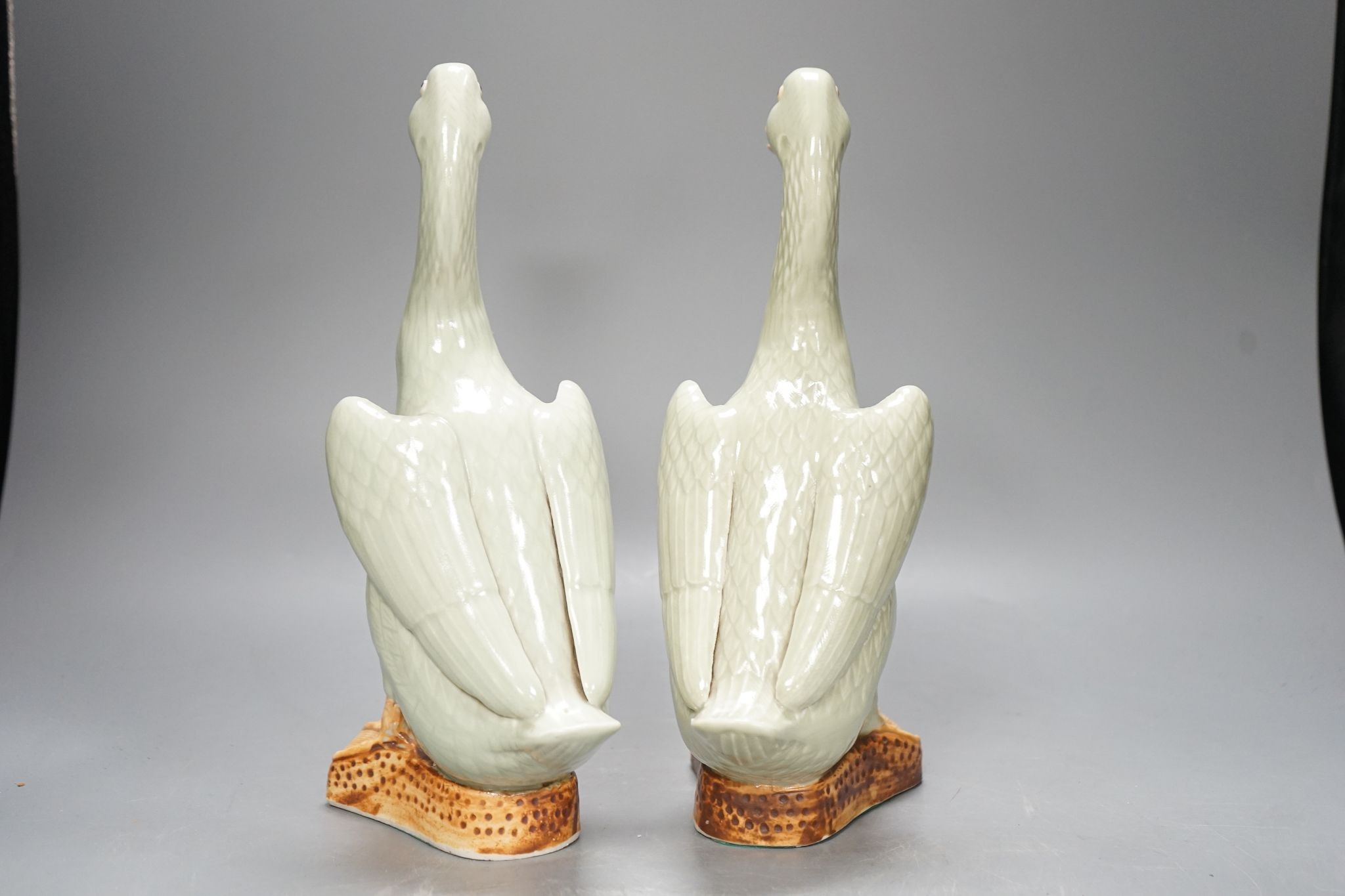 A pair of Chinese celadon glazed geese, 30cm